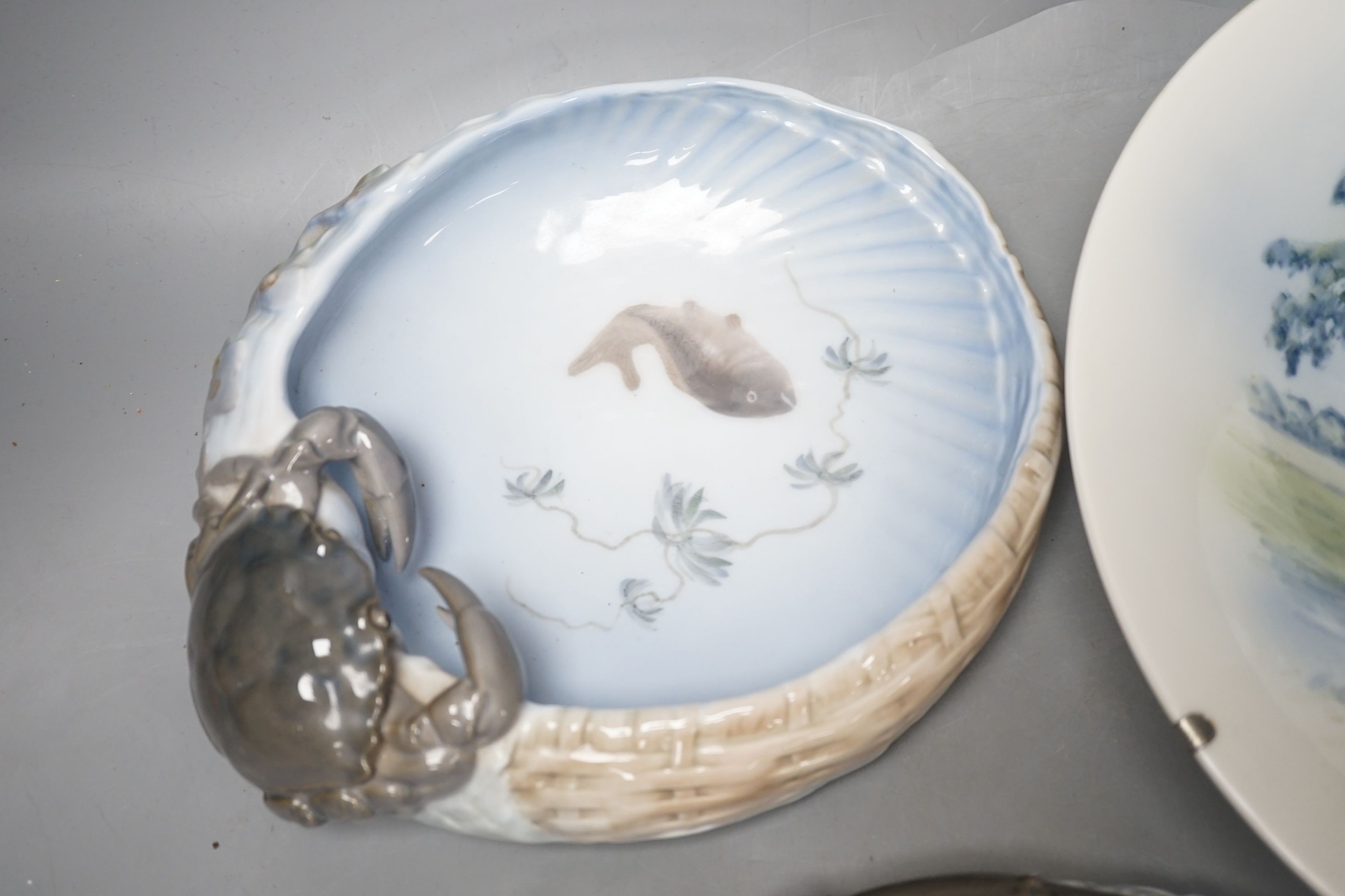 Three Royal Copenhagen dishes, one decorated with a crab, another with a lobster